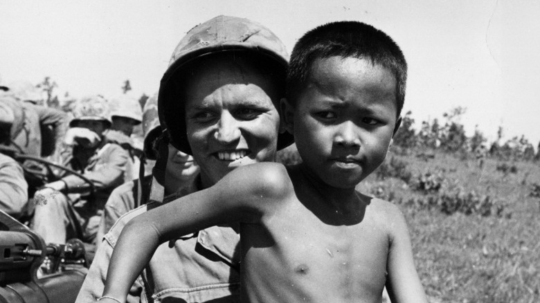 US soldier with child from Southeast Asia