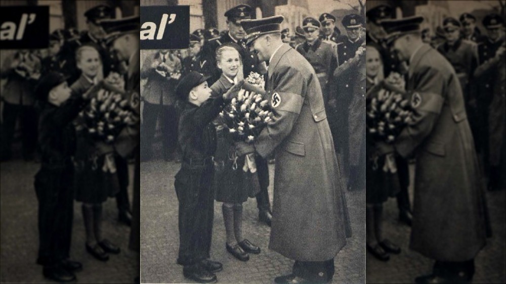 Hitler being given flowers by members of the Hitler Youth 