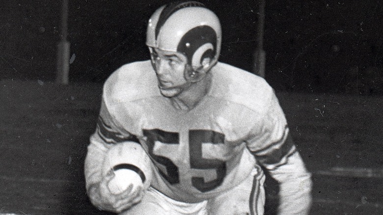 early Rams player holding football