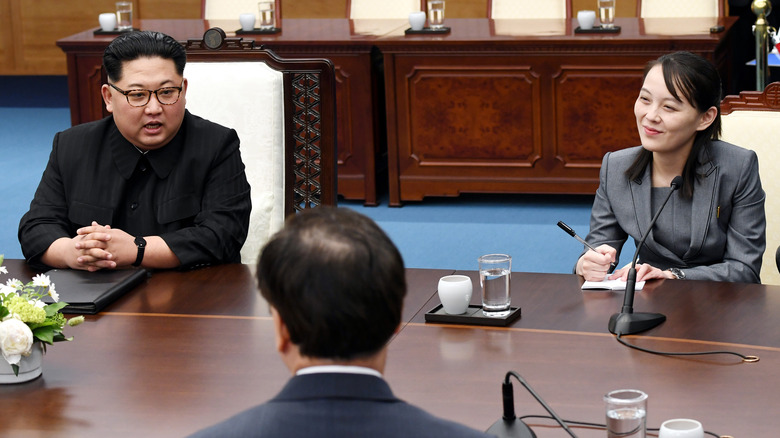 Kim Jong-un and Kim Yo-jong sitting at table