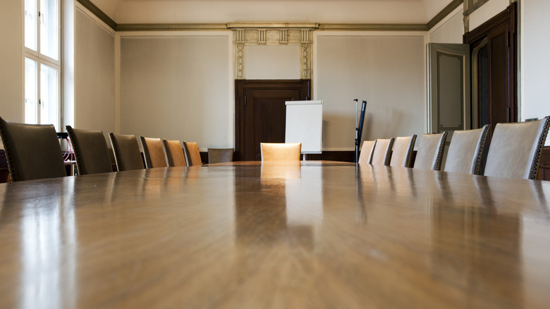 meeting table with empty chairs