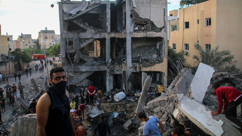 Palestinian emergency workers searching bombed building