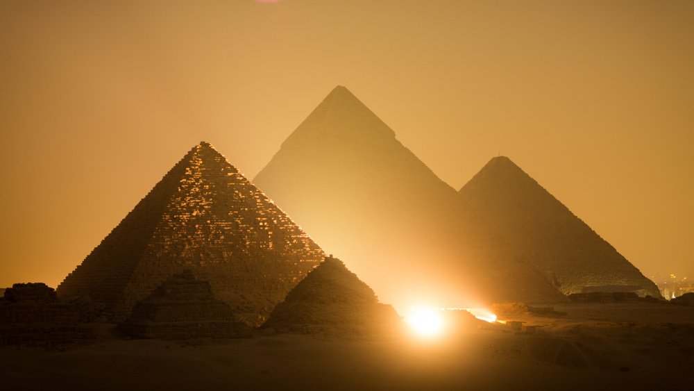 The Pyramids of Giza standing brilliantly in the dusk of Egypt