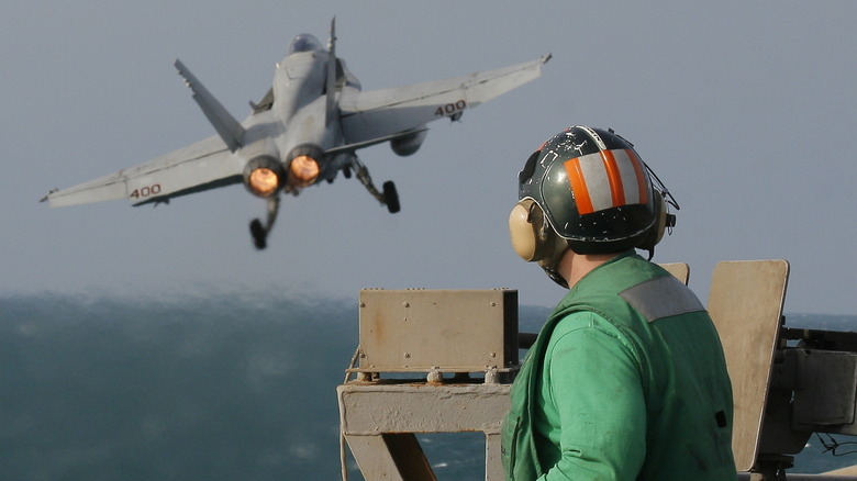 An F-18 taking off from the deck