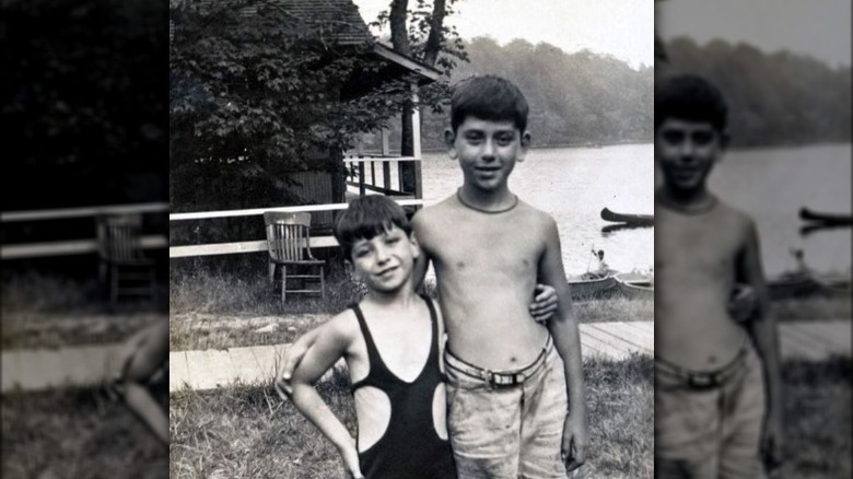 Young Sherman Brothers in front of lake