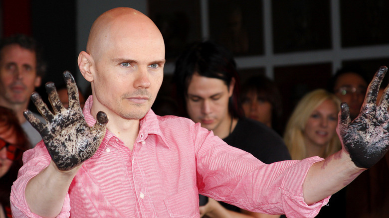 Billy Corgan holding dirty hands up
