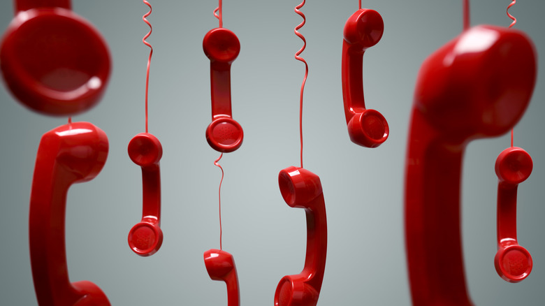 red phones hanging from cords