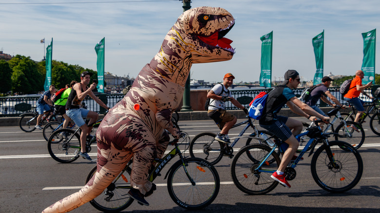 inflatable tyrannosaurus rex on bicycle