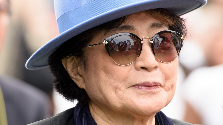 Yoko Ono blue hat smiling
