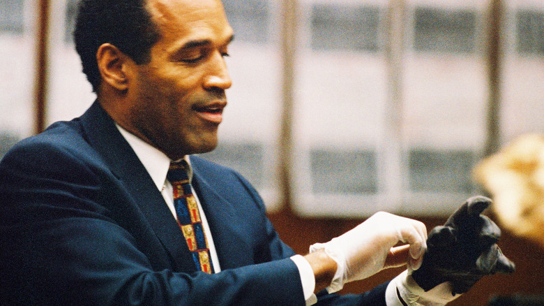 O.J. Simpson trying on gloves in court