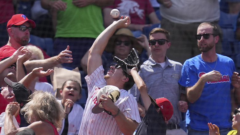 Fans fighting for foul ball in stands