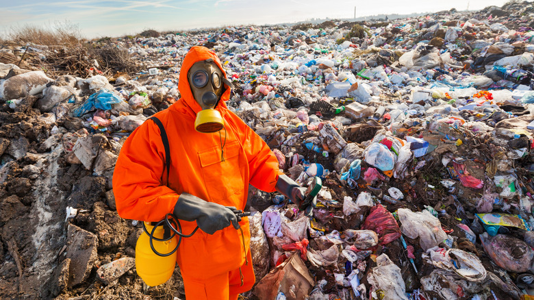 A scientist monitors an open-air landfill site