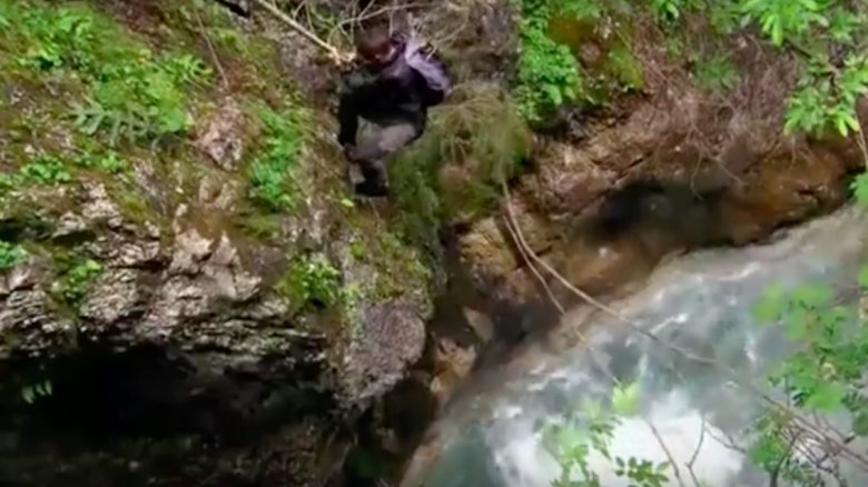 Bear Grylls climbing down waterfall