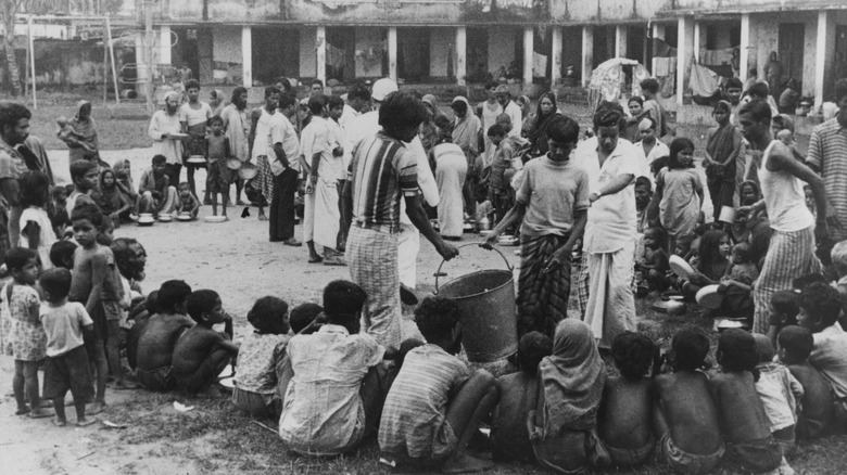 people waiting for rations during famine