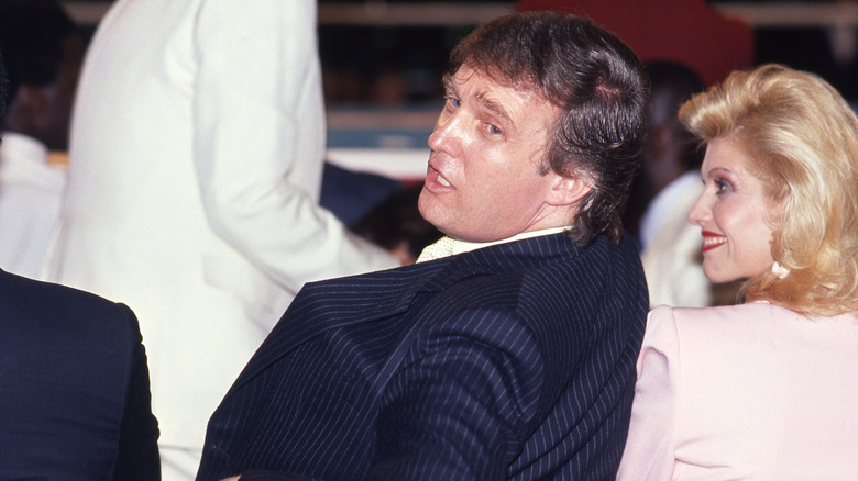 MIddle-aged Donald Trump seated by boxing ring