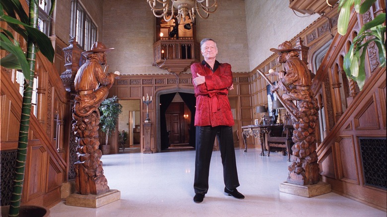 Hugh Hefner posing in Playboy Mansion