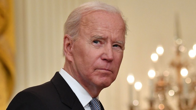 Joe Biden squinting looking grim