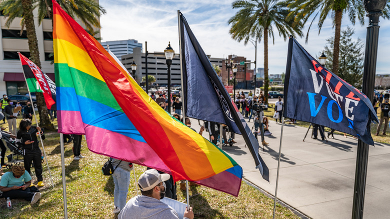 Protester with rainbow flag demonstrating in Jacksonville, Florida