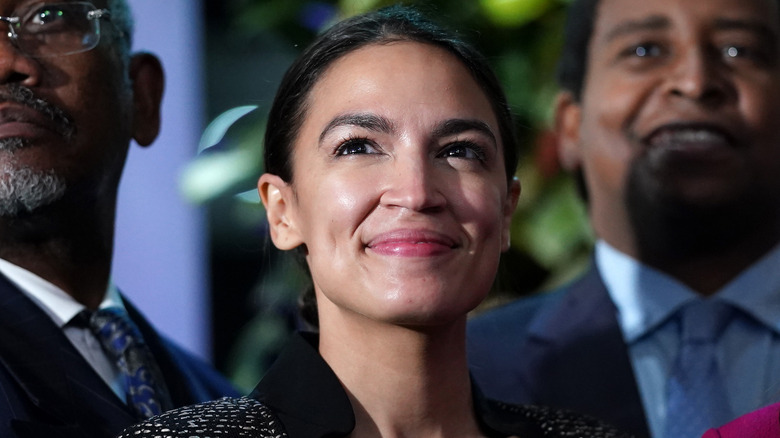 Alexandria Ocasio-Cortez smiling while posing for a picture