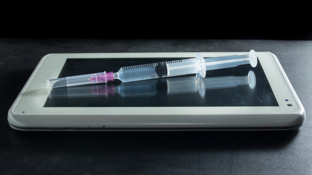 computer tablet, syringe 