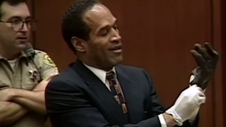 OJ Simpson smirking while trying on glove in court