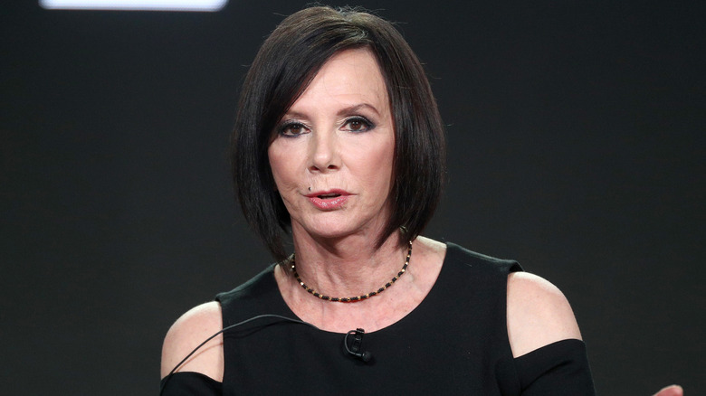 Marcia Clark seated while speaking