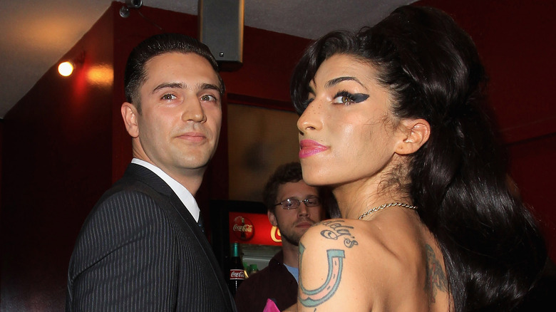 Reg Traviss and Amy Winehouse at event