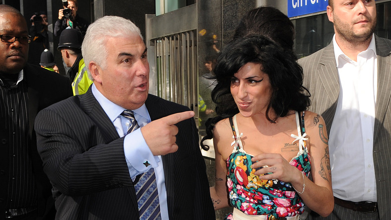 Mitch and Amy Winehouse walking with crowd