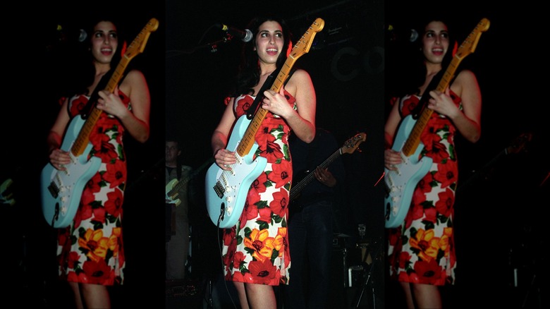 Amy Winehouse on stage with guitar