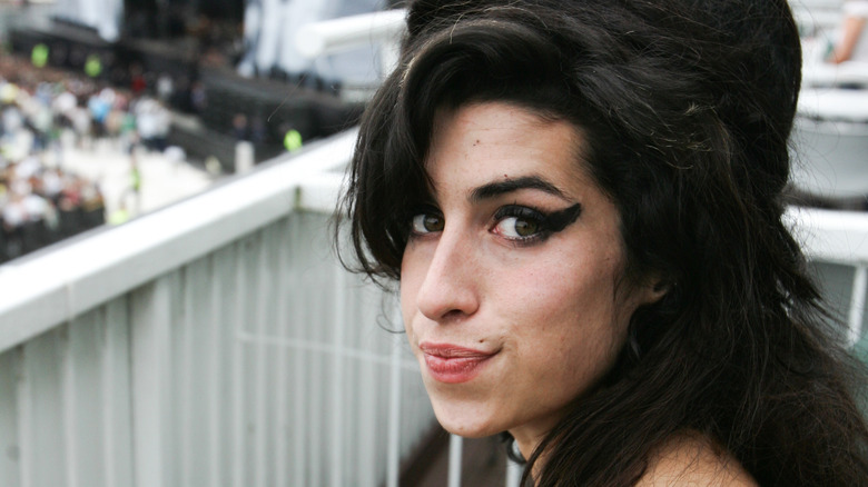 Amy Winehouse at music festival looking at camera