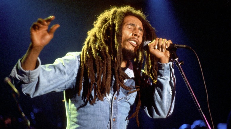 Bob Marley performing on stage singing mic