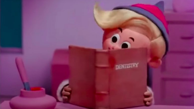 Hermey reading about dentistry