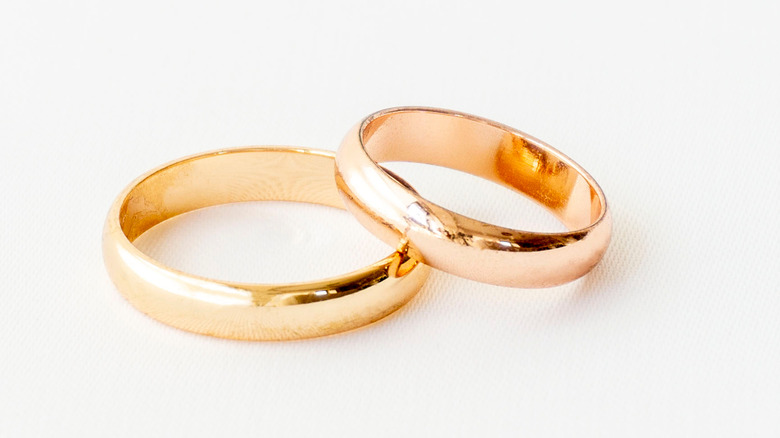 Two simple gold-band wedding rings.