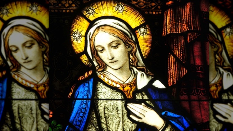 Stained glass window of the Virgin Mary with halo looking down