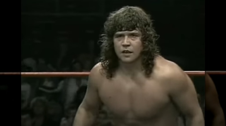 Chris Von Erich long curly hair shirtless in ring