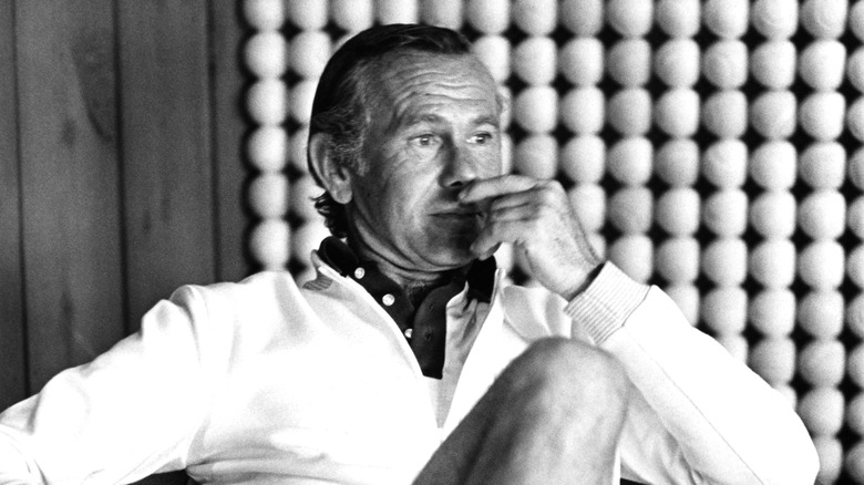 Johnny Carson seated in white shirt