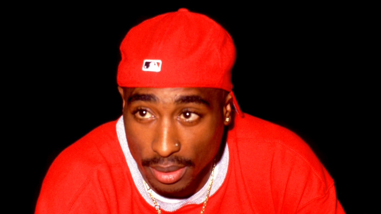 Tupac Shakur in red cap and shirt