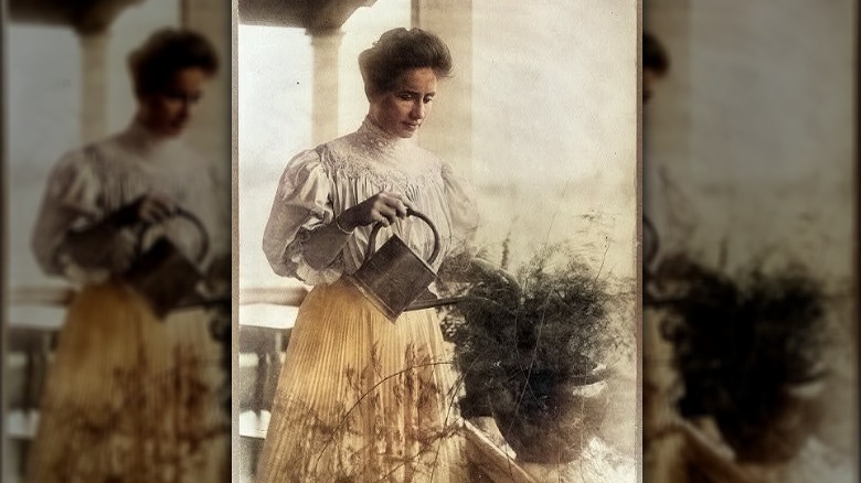 Colorized photo of Helen Keller watering a plant