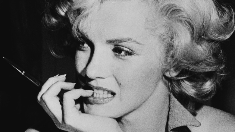 Marilyn Monroe biting her nails