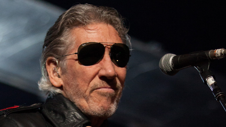 Roger Waters with sunglasses performing