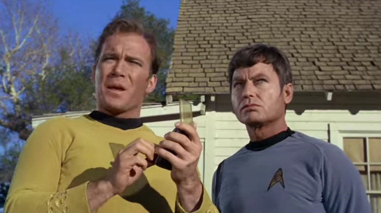 Kirk speaks into his communicator