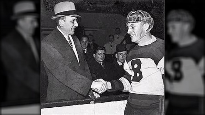 Ace Bailey of the Toronto Maple Leafs shaking hands with Boston Bruins defenseman Eddie Shore during a benefit NHL All-Star Game in Bailey's honor in 1934