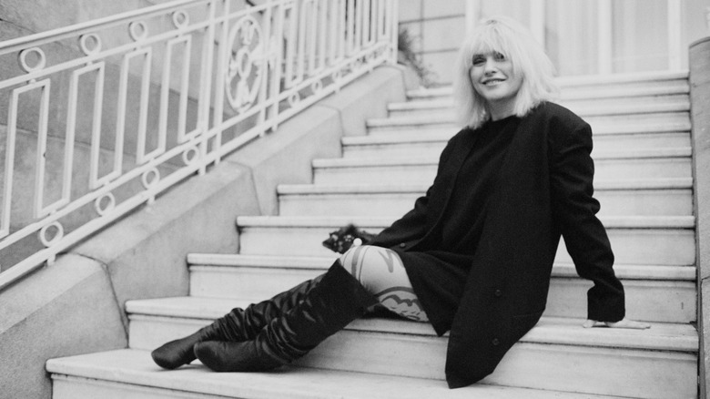 Debbie Harry smiling sitting on stairs