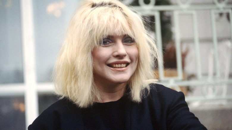 Young Debbie Harry smiling outside