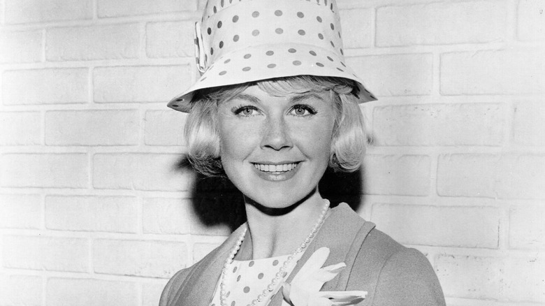 Doris Day, wearing hat, posing