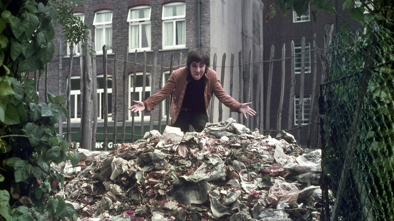 Keith Moon standing on top of garbage