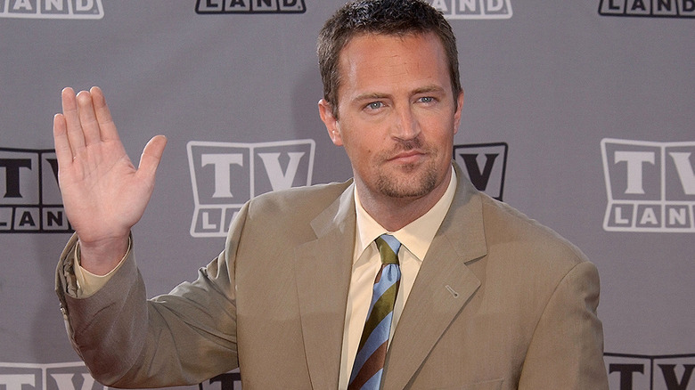 Matthew Perry smiling and waving