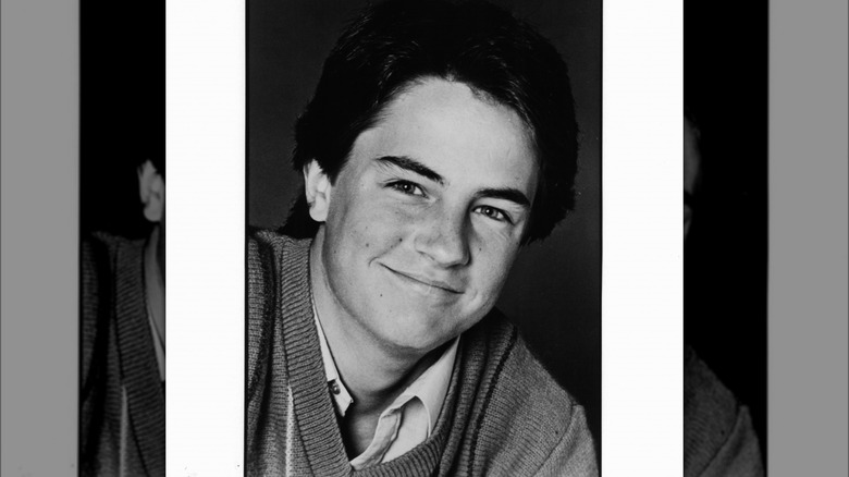 black and white headshot young Matthew Perry smiling