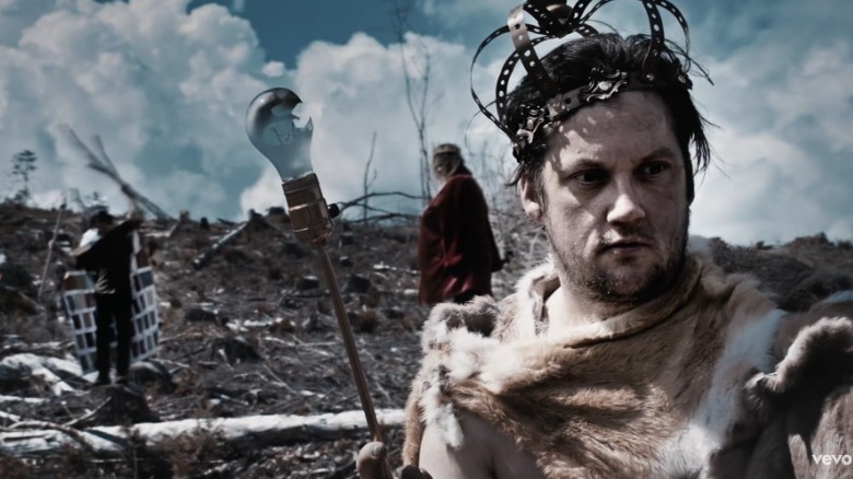Isaac Brock dressed as a king in video 