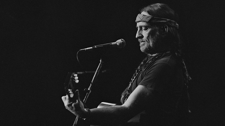 Willie Nelson onstage with guitar